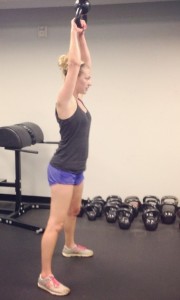 girl weight training with kettle bell
